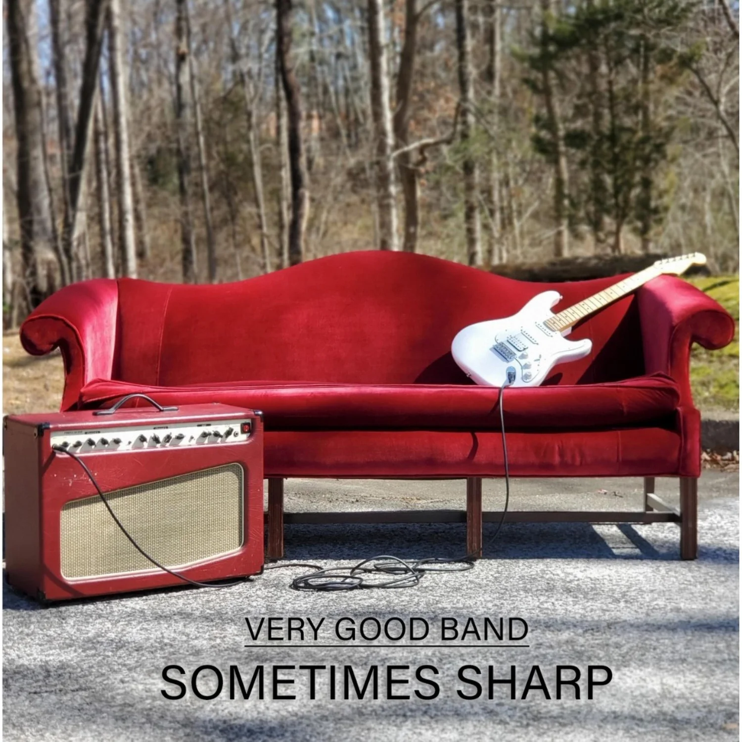 Cover of Sometimes Sharp: a red couch, guitar and amp on a driveway